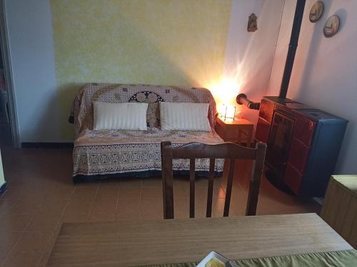 a room with a bed with a table and a chair at Cascina Marasca Appartamento Sole in Martina Olba