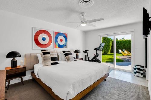 a bedroom with a bed and a ceiling fan at The Dexter Palm Springs- 1480 in Palm Springs