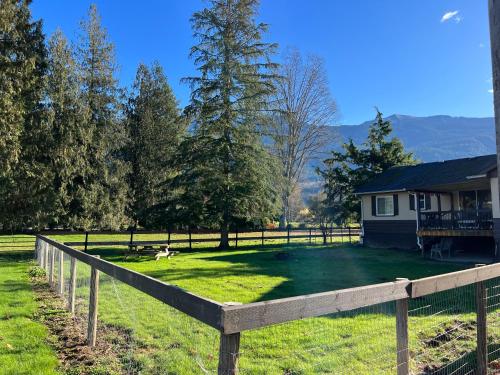 a wooden fence in front of a house at Farm House - L&S Farms in Chilliwack