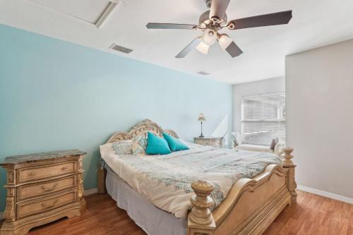 a bedroom with a bed and a ceiling fan at Pet-Friendly Cape Coral Retreat with Screened Porch! in Cape Coral