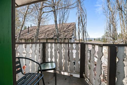a chair sitting on the balcony of a house at Black Forest Lodge in Big Bear Lake