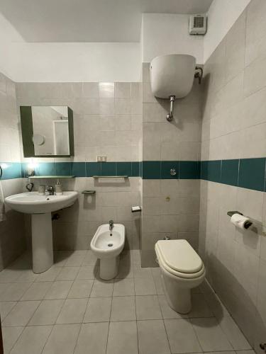 a bathroom with a toilet and a sink at Stanza classica Eur Tintoretto in Rome
