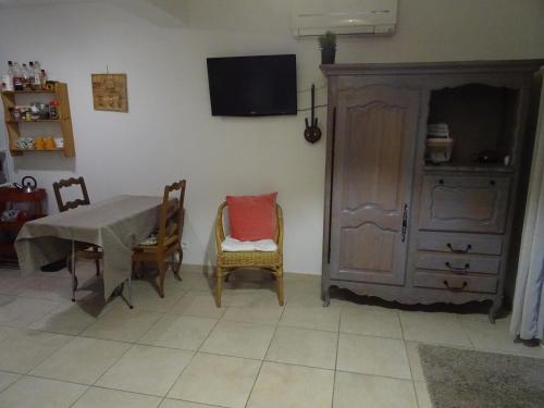 a dining room with a table and chairs and a cabinet at Les Ecrins d'Aix-en-Provence in Aix-en-Provence