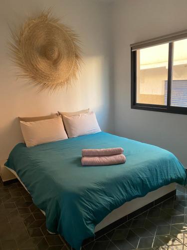 Una cama con dos toallas encima. en Appartement 1 Riad Dar Samar en Tamraght Ouzdar