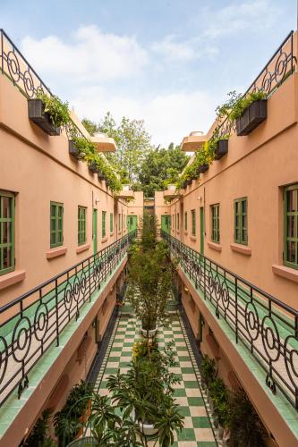 an empty corridor of a building with plants at Casa Oliva in Mexico City