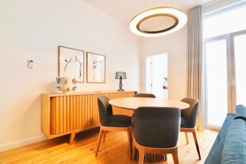 a dining room with a table and chairs at Biscainhos Flat By The Arch - Charming Apartments in the Historic Center in Braga