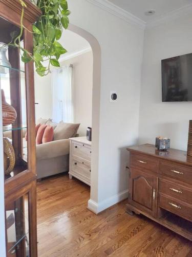 a living room with a couch and a mirror at Daisy's Heavenly Townhome in Alexandria
