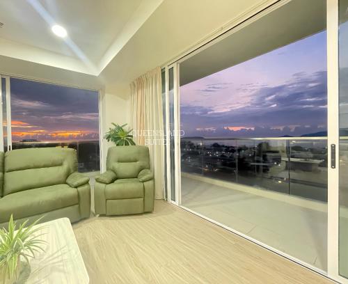a living room with a large window with a view at QUEENSLAND SUITES at Aru Suites, Kota Kinabalu in Kota Kinabalu