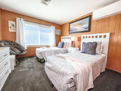 a bedroom with two beds and a window at Ocean front * Boardwalk * Private Balcony in Ocean City