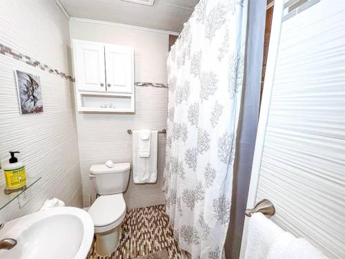 a bathroom with a toilet and a sink and a shower at Ocean front * Boardwalk * Private Balcony in Ocean City