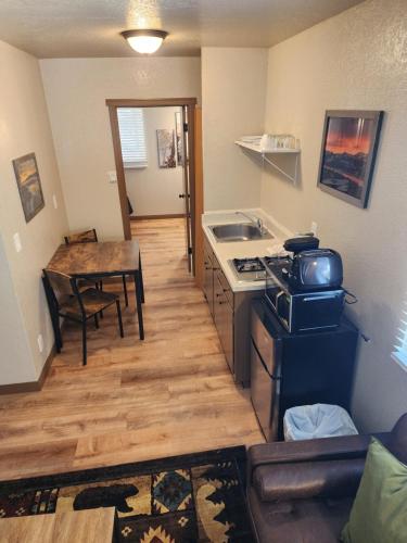 a kitchen with a table and a stove top oven at Black Forest Lodge in Big Bear Lake