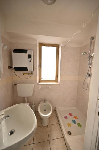 a small bathroom with a toilet and a sink at CASA LETIZIA in Ozzano Monferrato