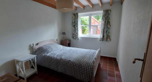 um quarto com uma cama e uma janela em Diksmuidse Ardennen 