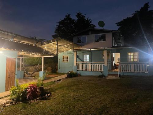 a house with a porch at night with lights at Cabaña Don Chacon in Paso Ancho