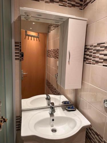a bathroom with a white sink and a mirror at Rooms Gollner in Zagreb