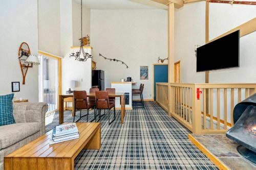 a living room with a couch and a tv at Outbound Mammoth in Mammoth Lakes