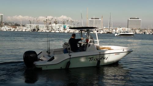 a man sitting in a boat in the water at Luxury Afloat Yacht Paradise 3 bedrooms 3bath 5 beds with full Marina view in Los Angeles