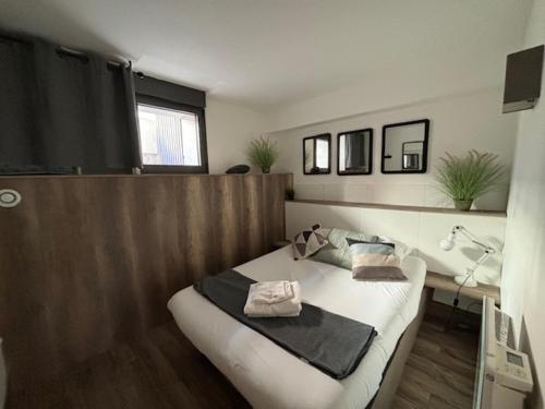 a bedroom with a bed with towels on it at Casa Hotel in Aix-en-Provence