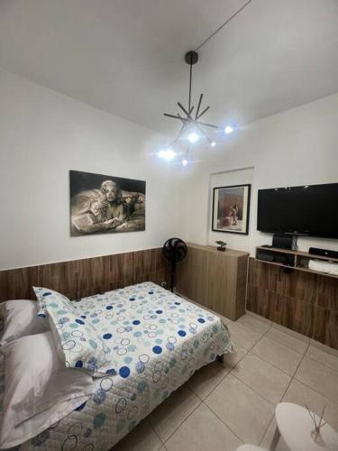 a bedroom with a bed and a flat screen tv at Exclusivo sector de la 70 laureles in Medellín