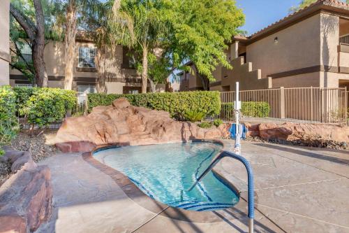 a swimming pool with a slide in a yard at Hilton Vacation Club Desert Retreat Las Vegas in Las Vegas