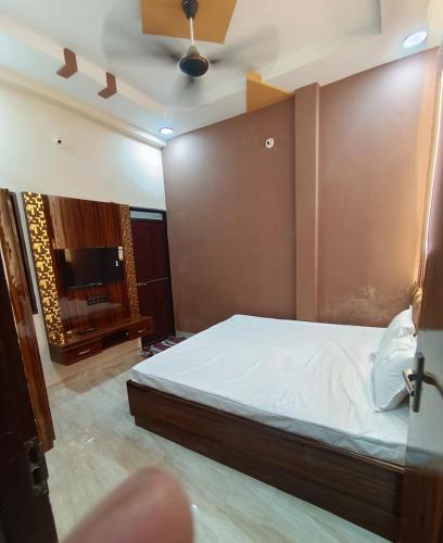 a bedroom with a bed and a flat screen tv at Hari Har vila house Air conditioner Full vila for rent in Ujjain
