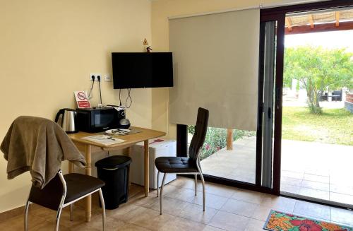 a room with a desk with a computer and chairs at Winter Wonderland in Puerto de Santiago