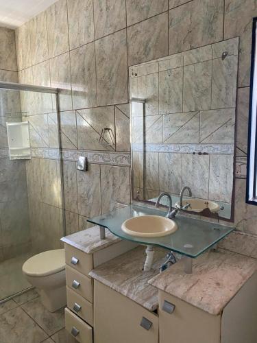 a bathroom with a sink and a toilet at Casa da Cris in Penha