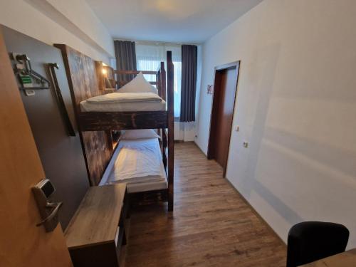 a hallway with three bunk beds in a room at Center Hotel Essen in Essen