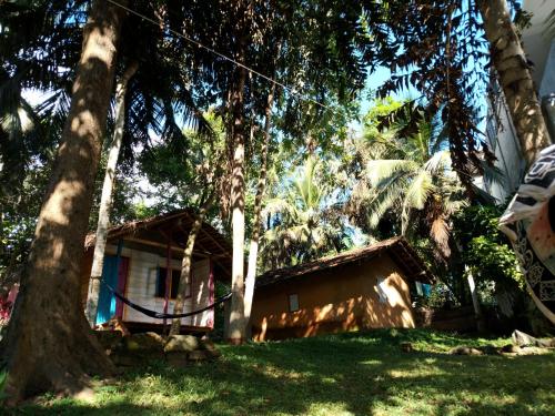 a house with a tree in front of it at Hidden Well Hiriketiya in Hiriketiya