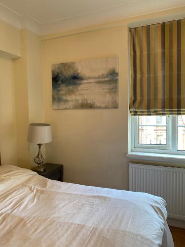 a bedroom with a bed and a window at Central London Double Bedroom by Station in London