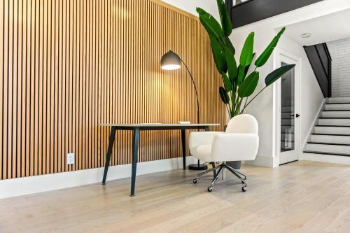 an office with a table and a chair and a plant at Ellum House in Dallas