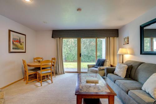 a living room with a couch and a table at Door County Getaway - Walk to State Park! in Fish Creek
