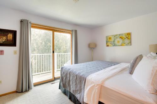 a bedroom with a bed and a large window at Door County Getaway - Walk to State Park! in Fish Creek