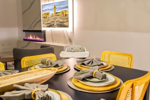 a dining room with a table with yellow chairs at Ellum House in Dallas
