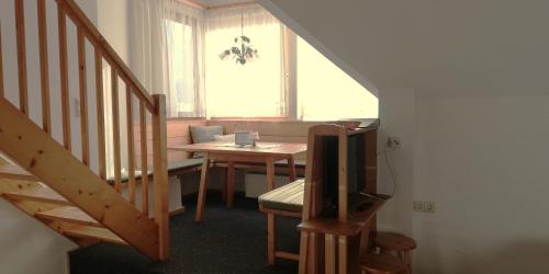 a dining room with a table and a tv in a room at Abenteuerhof in Weißenbach