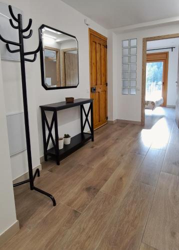 a living room with a table and a mirror at Cal Bardillo in Bagá