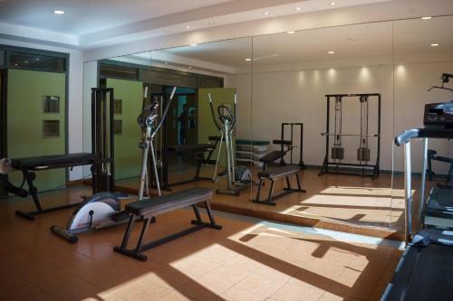 a gym with several treadmills and exercise equipment at Hostal del Sol in San Bernardo