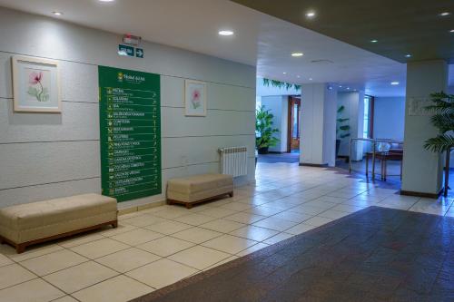 a waiting room with benches and a sign on the wall at Hostal del Sol in San Bernardo