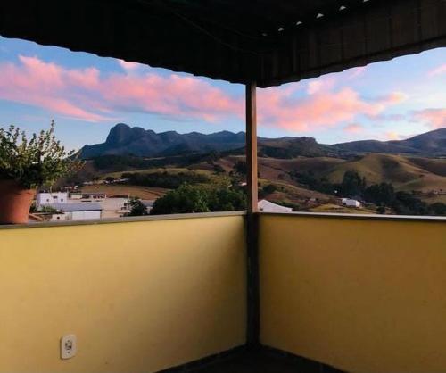 a view of a mountain view from a window at Pousada Recanto das Flores in Aiuruoca