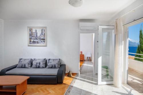 a living room with a couch and a table at Villa Jana in Marusici 