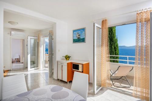 a living room with a balcony with a view of the ocean at Villa Jana in Marusici 