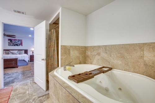a large bathroom with a tub and a bedroom at New Orleans Retreat about 7 Mi to French Quarter! in New Orleans