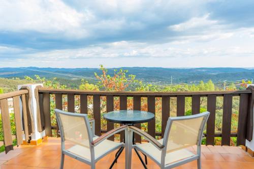 a table and two chairs on a balcony with a view at Complejo Los Veneros in Santa Ana la Real