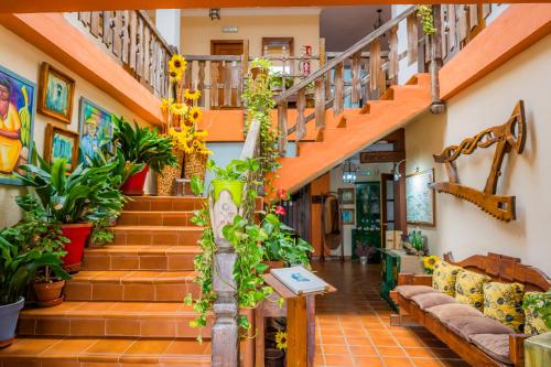 a living room with stairs and plants at Complejo Los Veneros in Santa Ana la Real