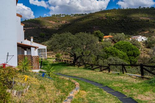 a house on the side of a hill at Complejo Los Veneros in Santa Ana la Real