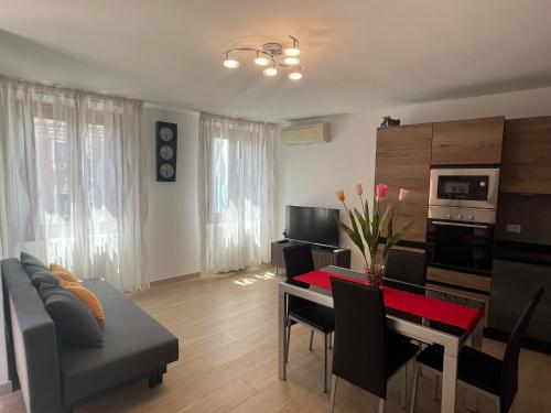 a living room with a couch and a dining room at ELDA HOUSE VENICE in Venice
