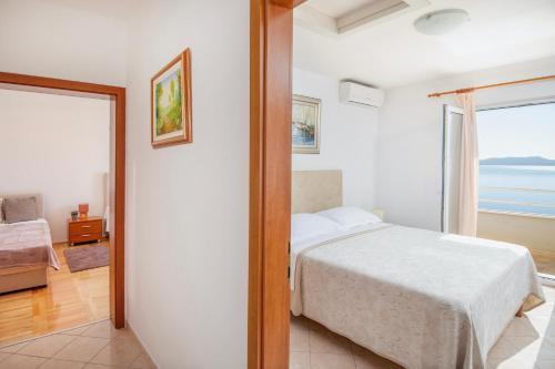a bedroom with a bed and a view of the ocean at Villa Jana in Marusici 