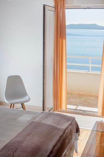 a bedroom with a bed and a view of the ocean at Villa Jana in Marusici 