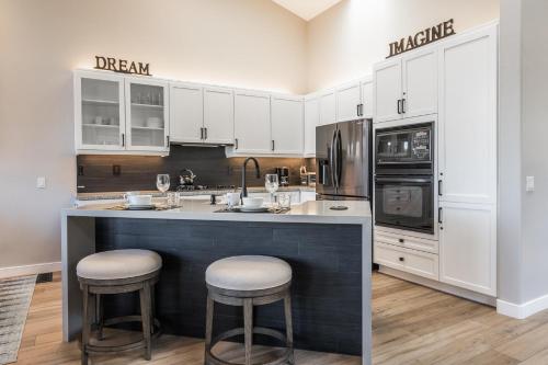 a kitchen with a large island with two bar stools at Snowcreek V 972 in Mammoth Lakes