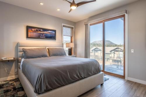 a bedroom with a bed and a large window at Snowcreek V 972 in Mammoth Lakes
